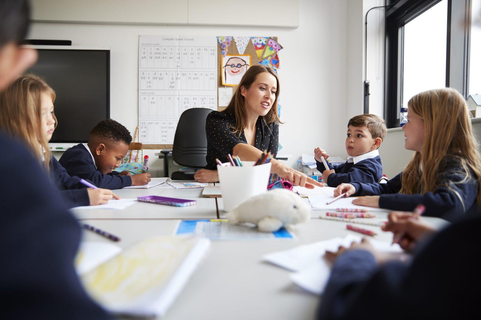 A supply teacher working with a small group